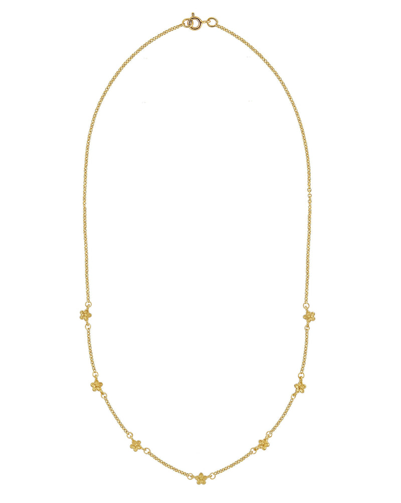 solid yellow gold station necklace with small flowers dotted along the chain